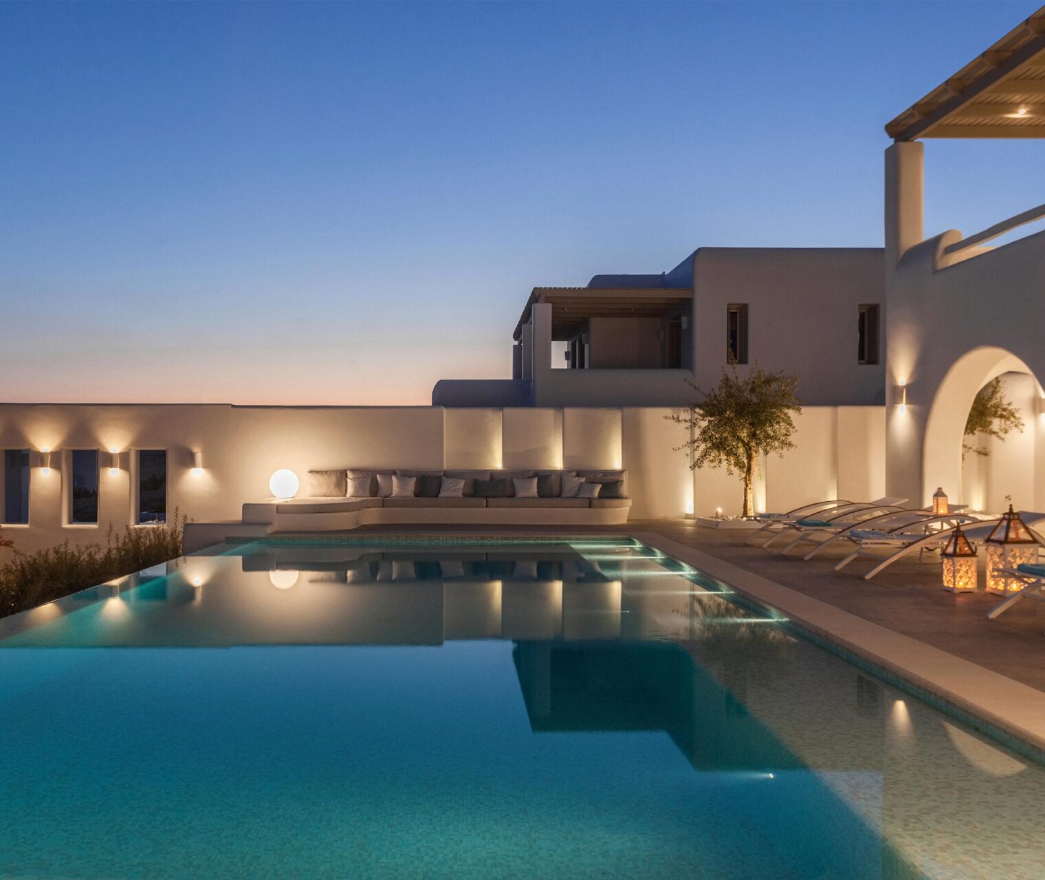 V1.19-Pool-lights-and-lounge-area-lit-up-at-night-in-Luxury-villa-Paros